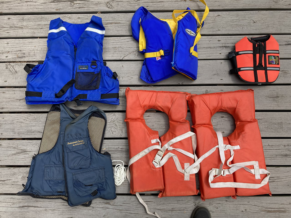 SIX floatation devices/water vests (and fishing vest) for the family–including the dog!