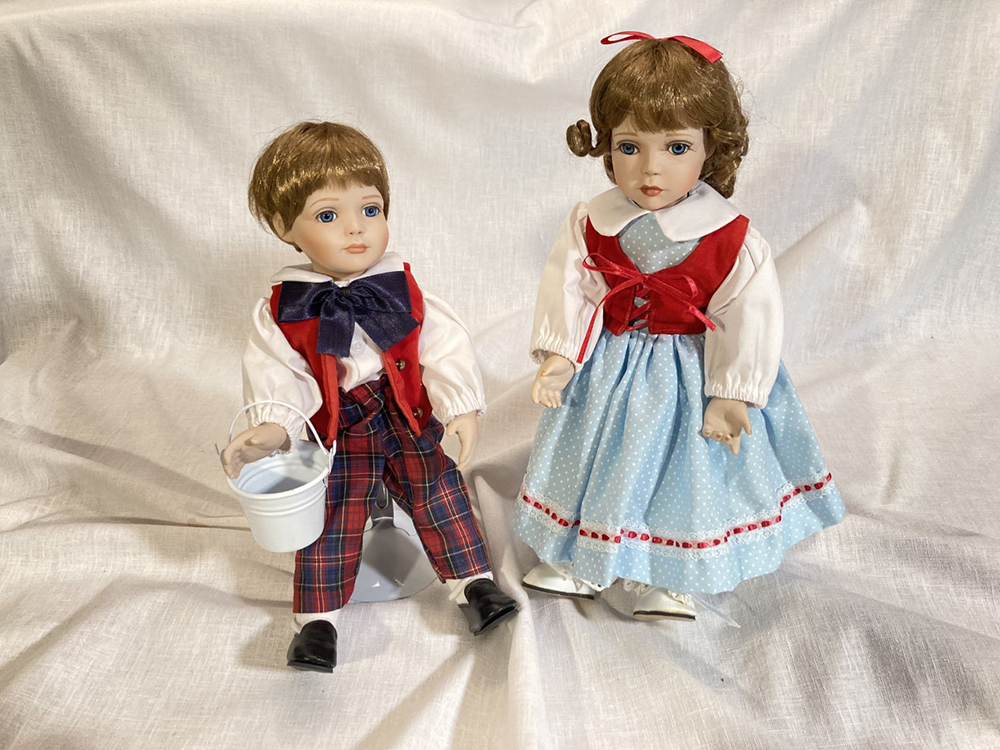 SUPER REDUCED to $40 for the pair. Collectible porcelain Jack and Jill dolls on stands (each 12″ tall)